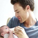 Dad feeding baby from a bottle