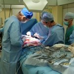 Doctors perform abdominal surgery