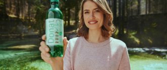 A woman holds a Donat Mg bottle in her hands.